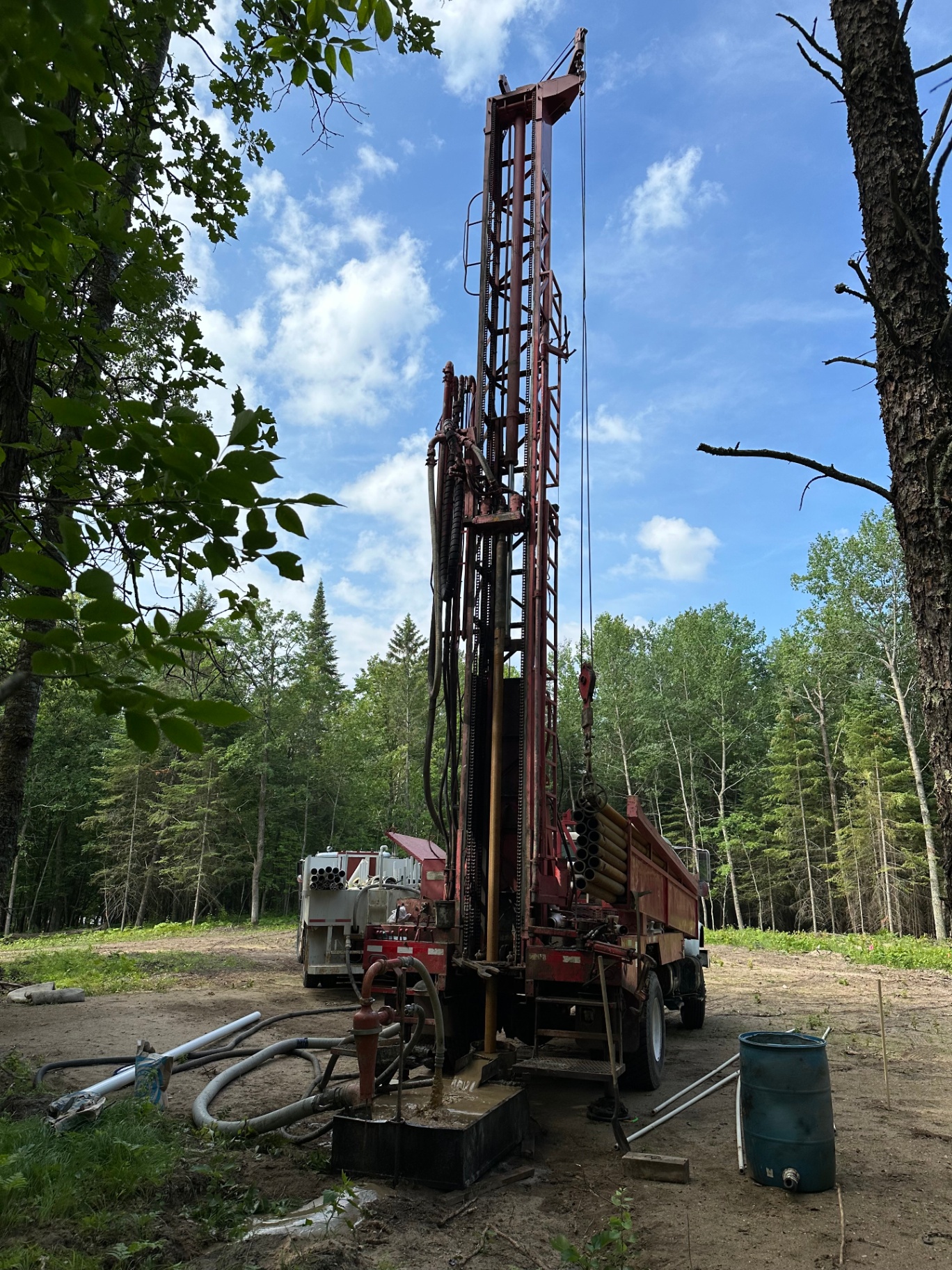 WESKO drilling rig set up in a Minnesota forest clearing